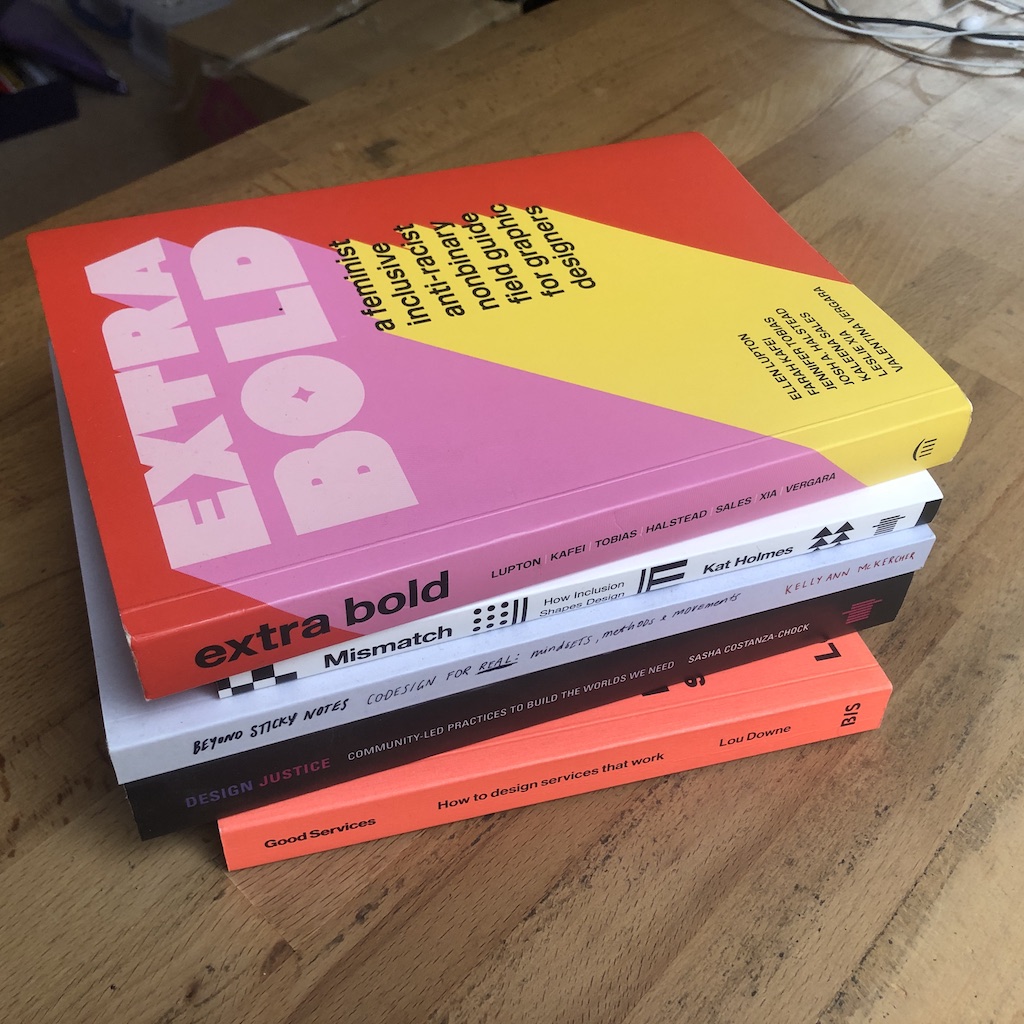 A pile of books on a desk. The books are Extra Bold, Mismatch, Beyond Sticky Notes, Design Justice and Good Services.