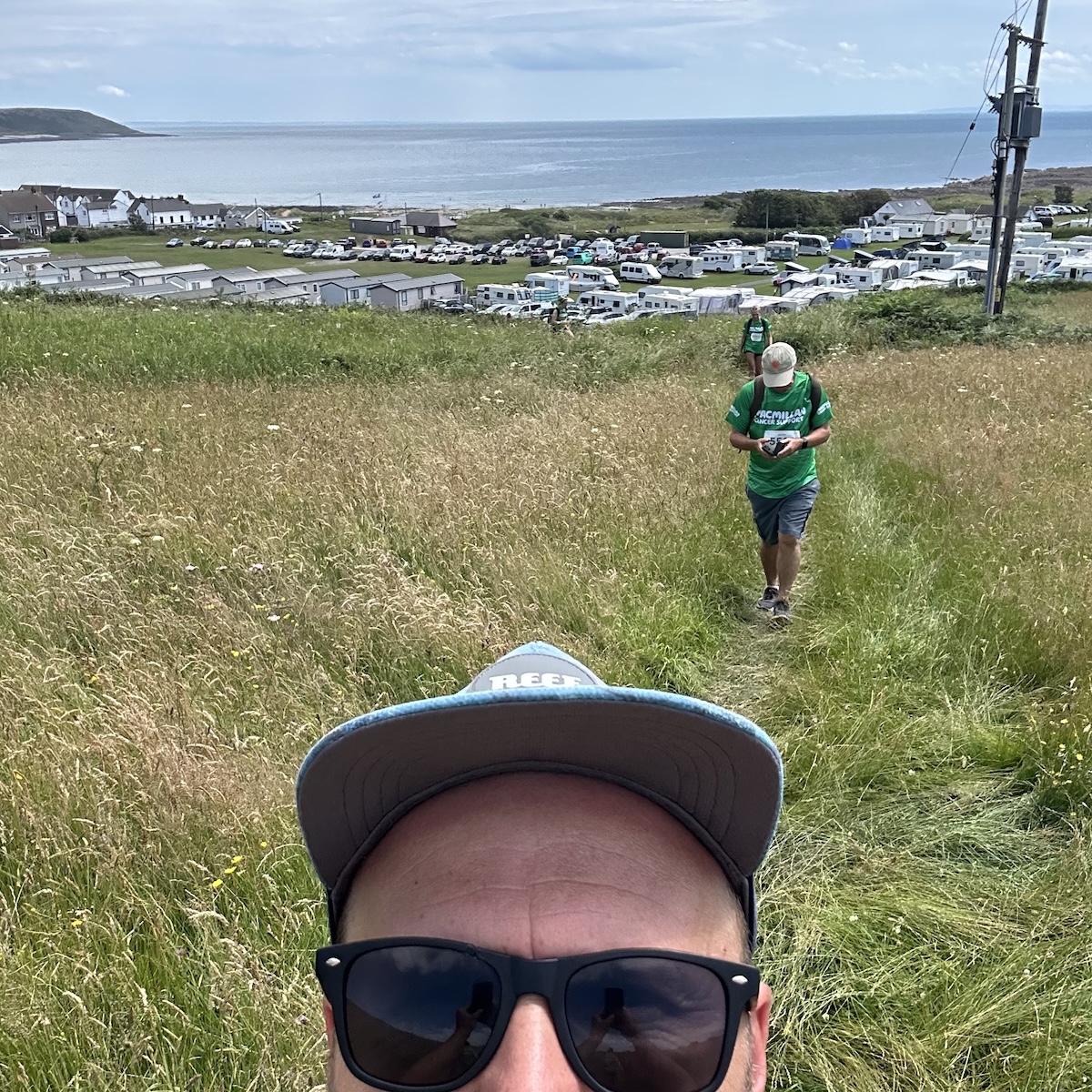 A selfie of the top of my head as I walk up a hill away from a caravan site near the beach.