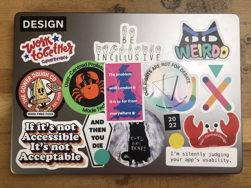 A Macbook Pro covered in colourful stickers